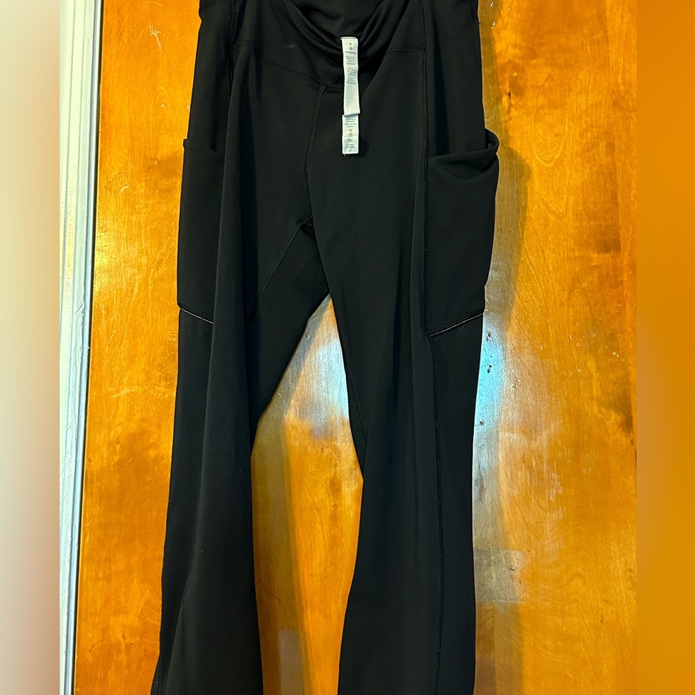 high waisted,black Lululemon leggings with pockets and a zipper in the back.